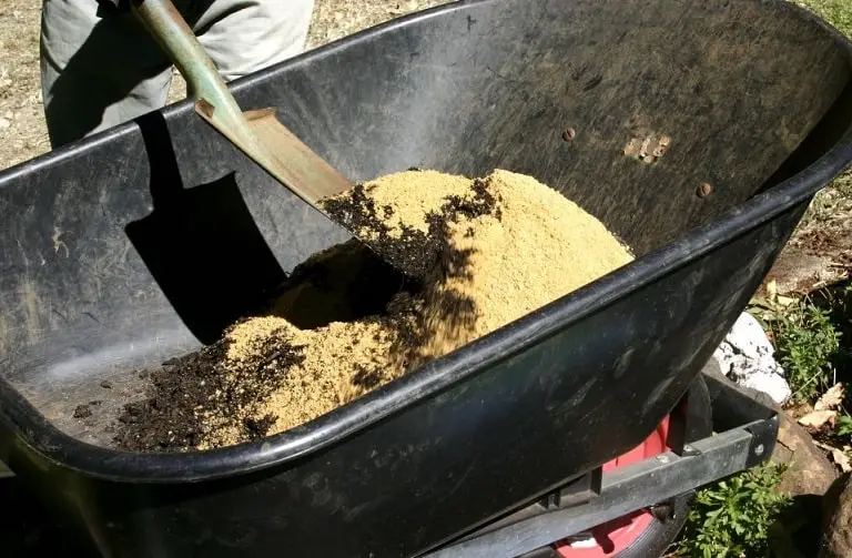 Gardener Mixing Sand with Soil