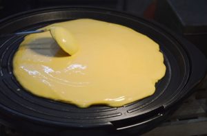 crape cake cooking on electric teflon pan