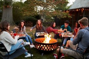 people sit around fire pit